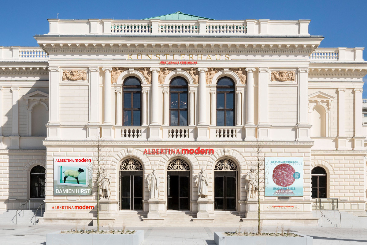 Front view of the neoclassical ALBERTINA MODERN building with statues, columns and exhibition posters © Rupert Steiner