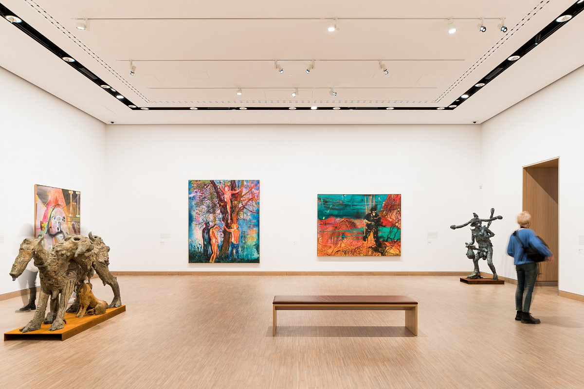 Visitors in a bright exhibition space with abstract sculptures and colorful paintings | Photo © Robert Bodnar