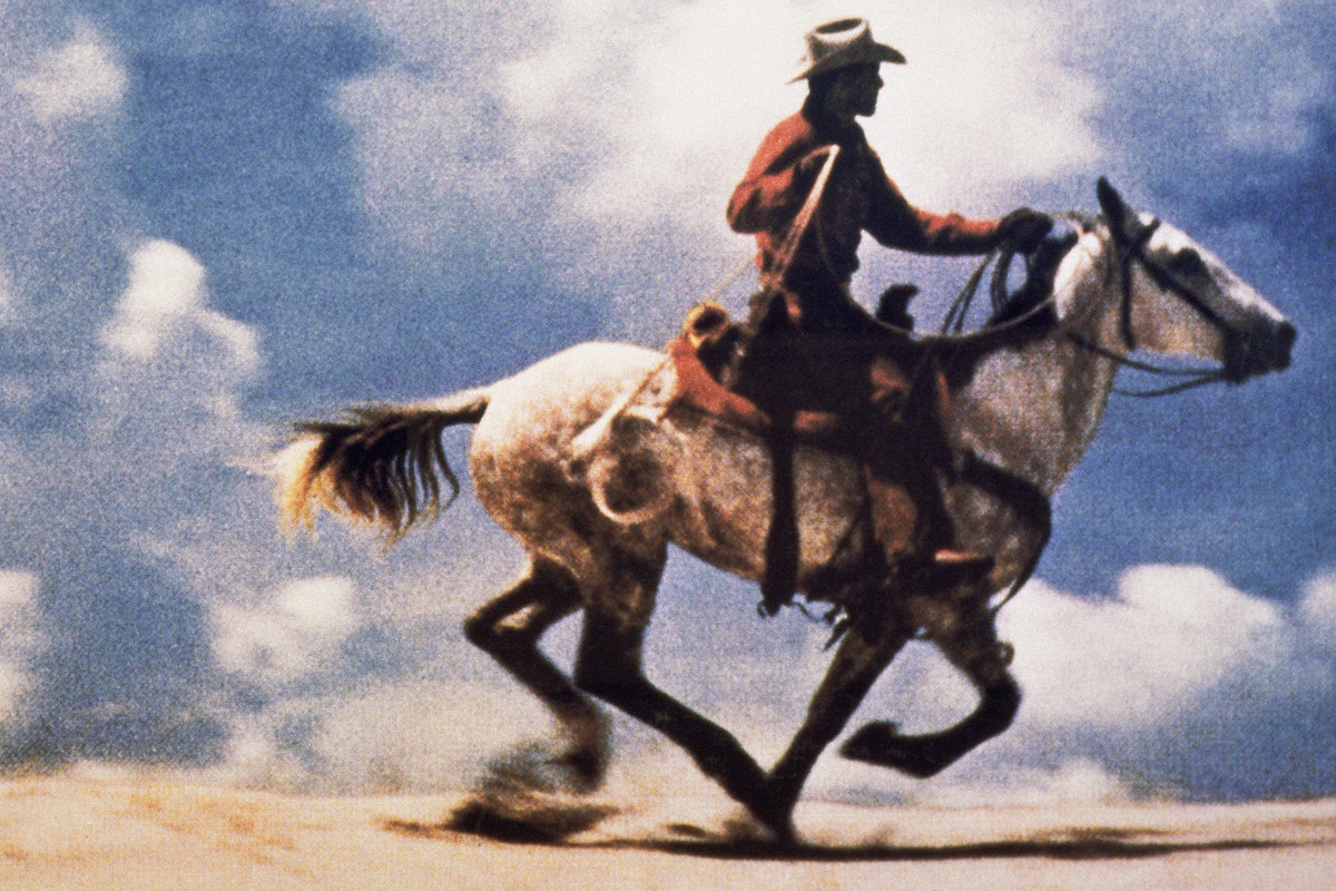 Color photograph of a cowboy riding a galloping horse in an open landscape; large-scale, horizontal composition. Credit: Richard Prince | Untitled (Cowboy), 1989 | Courtesy of Richard Prince Studio © Richard Prince