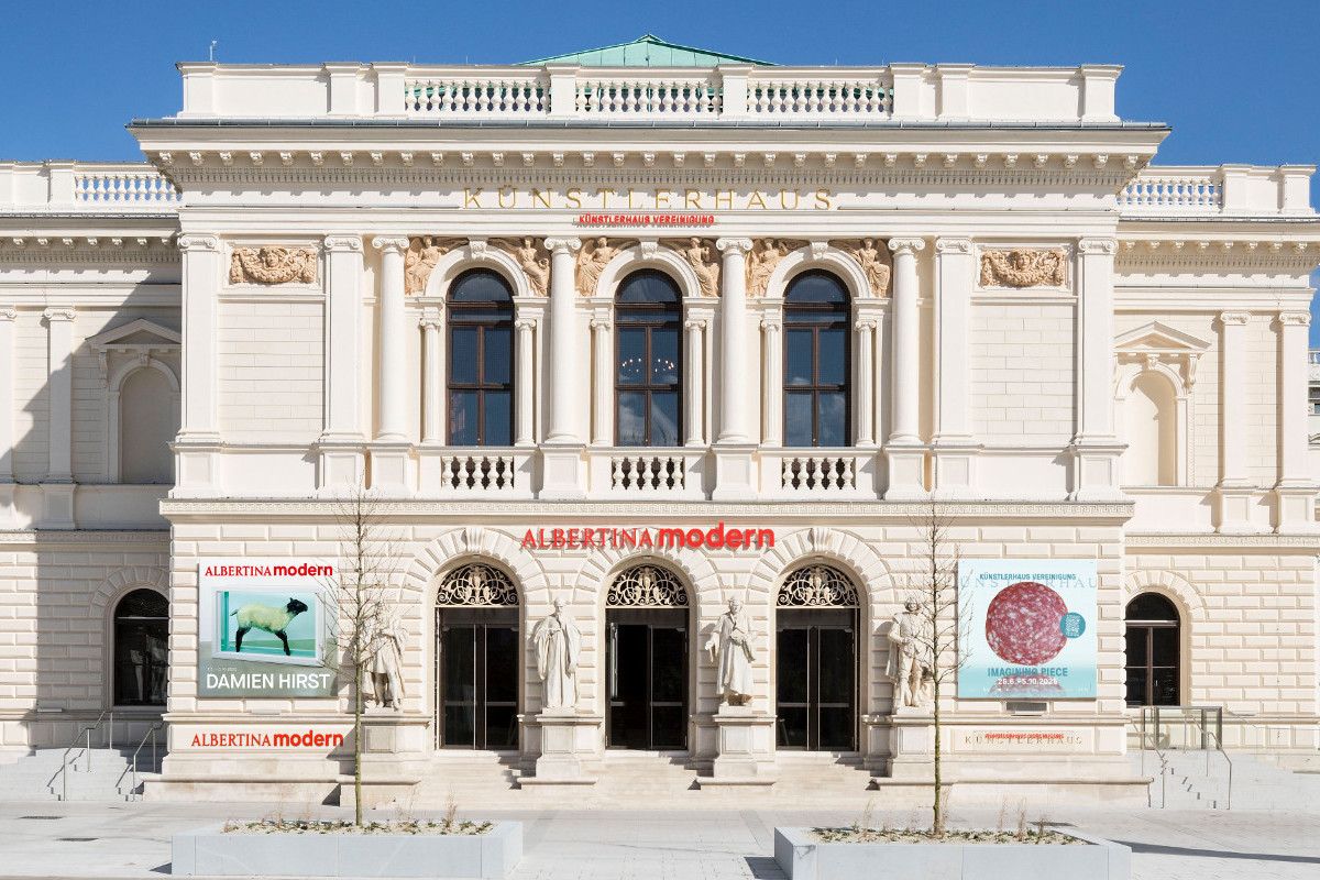 Front view of the neoclassical ALBERTINA MODERN building with statues, columns and exhibition posters | Photo (Mockup) © Rupert Steiner