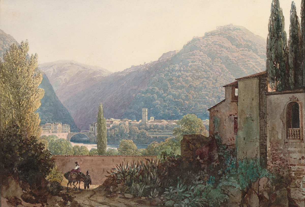 A Mediterranean landscape, hills planted with trees in the background, a town in front. In the foreground an Italian-style building and a wall. A man is walking in front of the wall with a horse on a lead. A woman with a long dress is sitting on the horse and the horse is carrying loads in baskets on both sides.