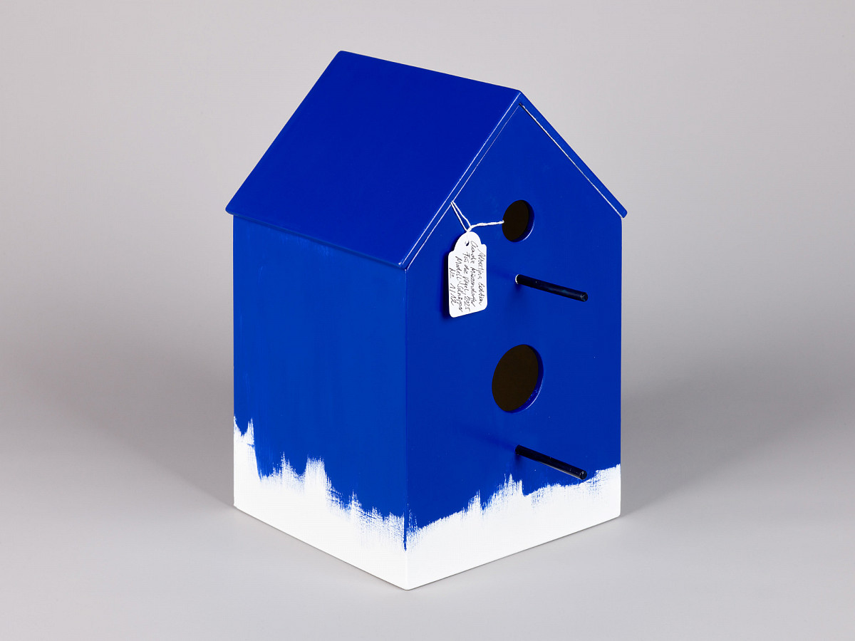 Birdhouse in blue with white trim on the underside.