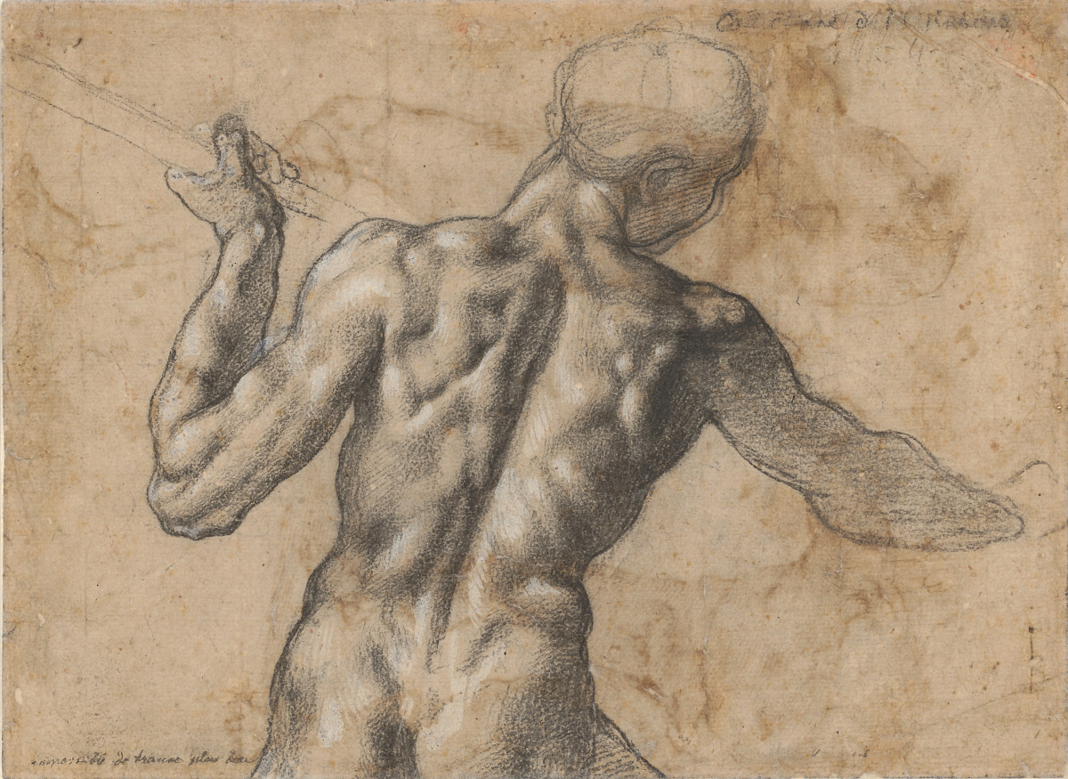 A view from behind of a naked man holding a spear.