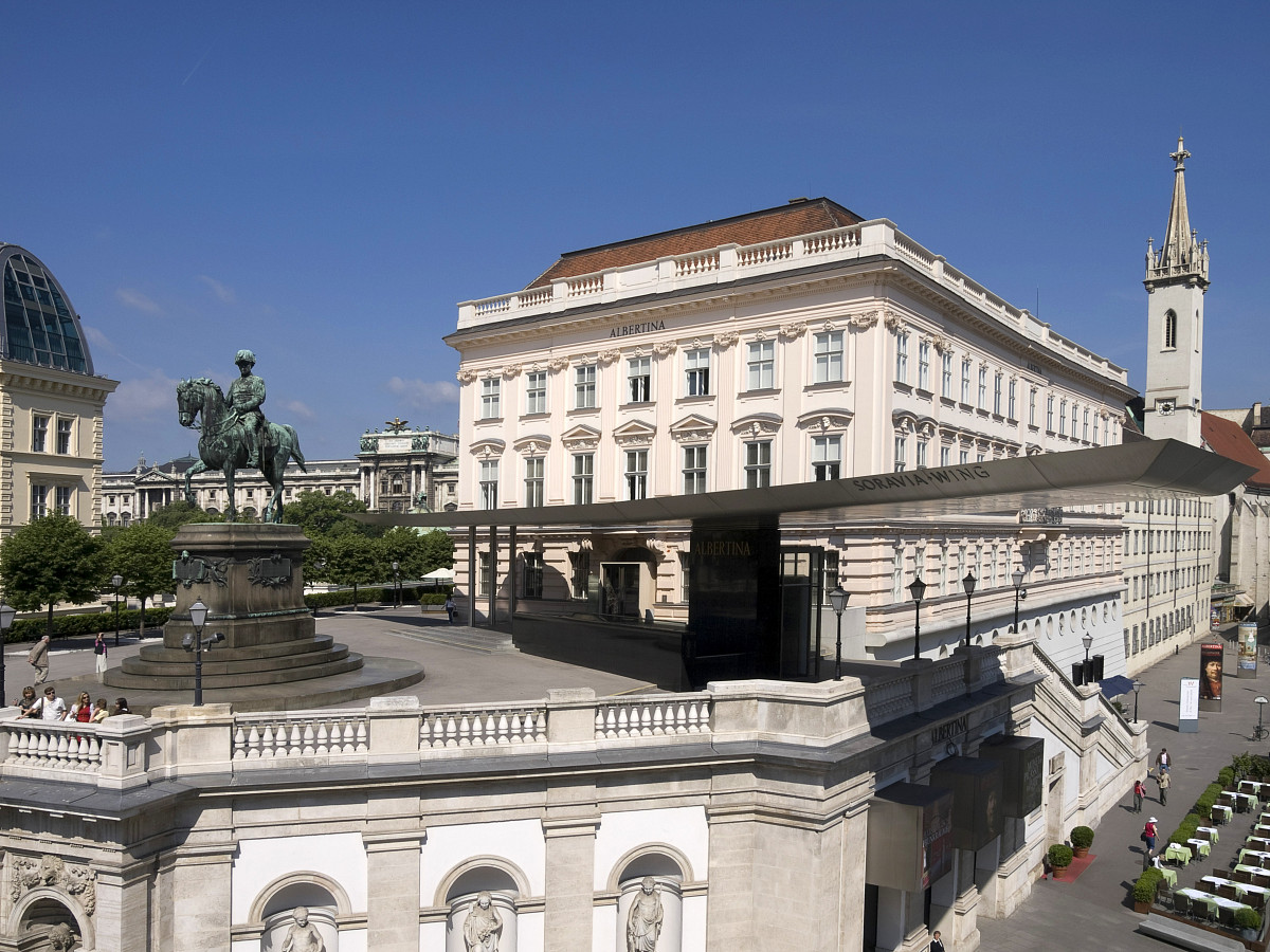 An exterior view of the ALBERTINA, with views of the Bastei and the Soravia Wing under a blue sky and sunshine.