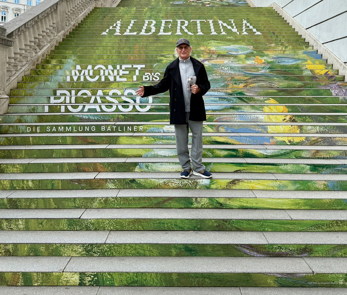 Otto Waalkes steht mit einem Ottifanten auf der großen Außentreppe der ALBERTINA.