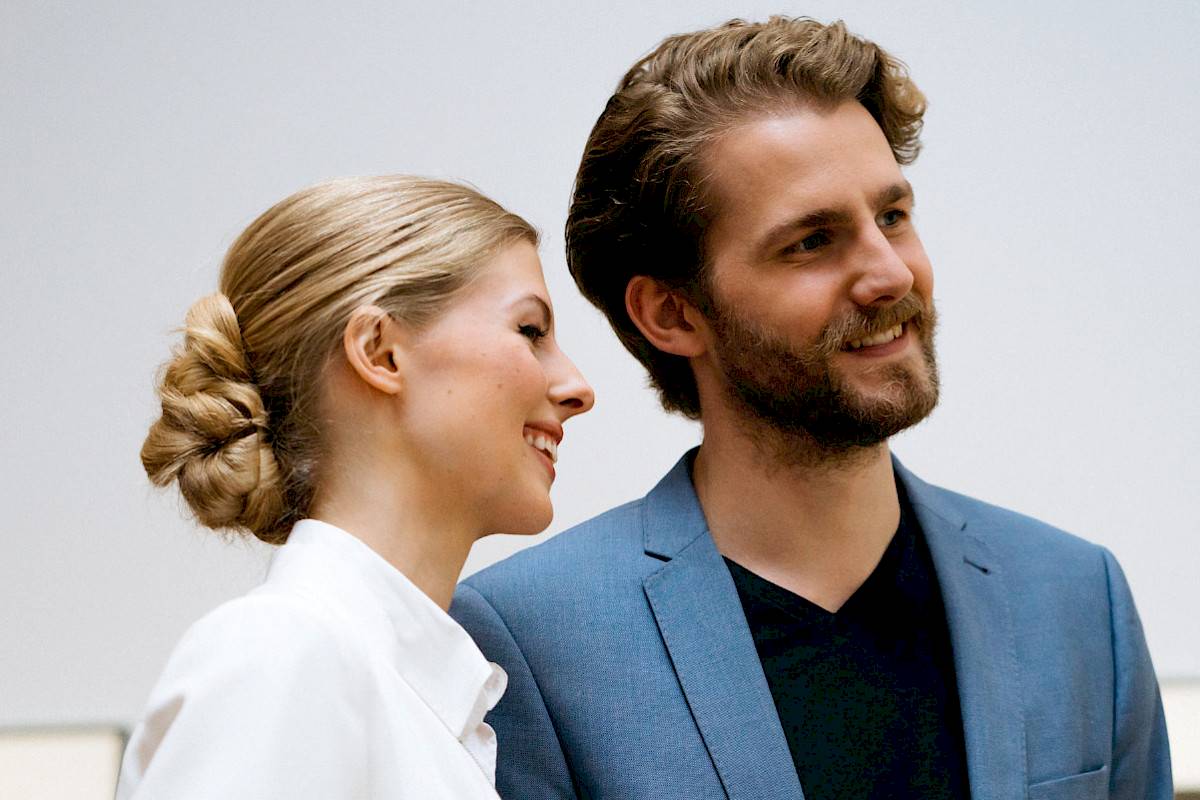 Two people stand smiling in the exhibition | Photo © Marko Mestrovic